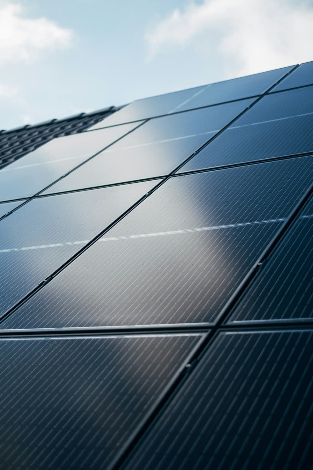 Clean black solar panels under a blue sky